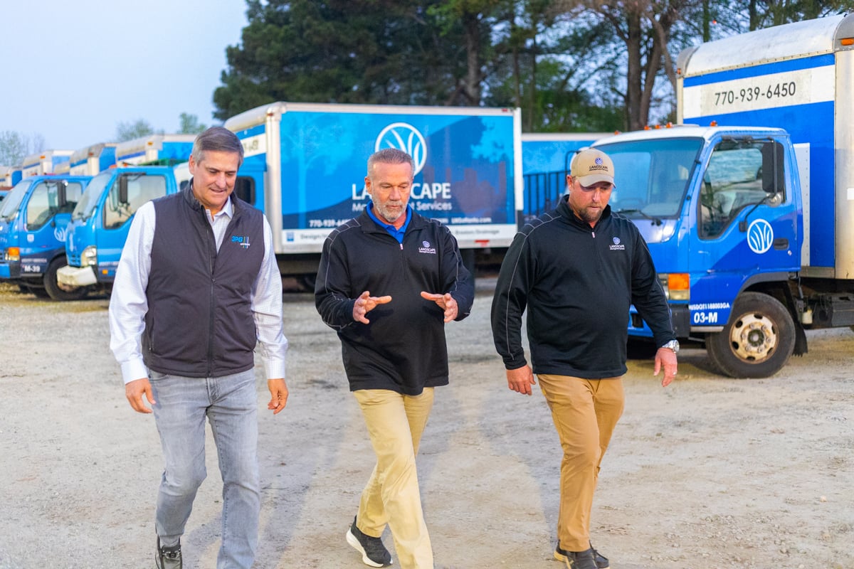 landscape management services company owner jeff harkness and manager walking through yard & shop during morning rollout 3